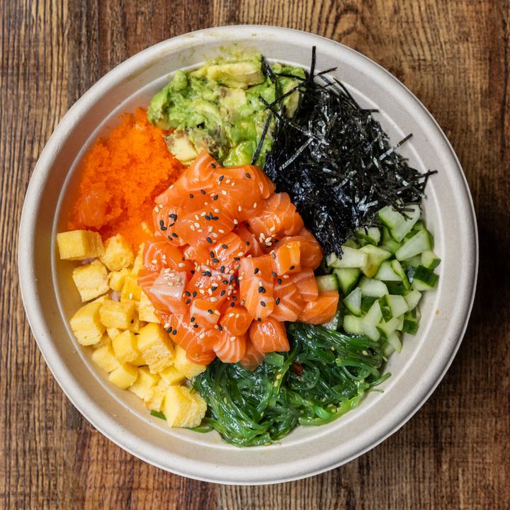 Classic California poke bowl: salmon, avocado, tamago, wakame and orange masago on rice